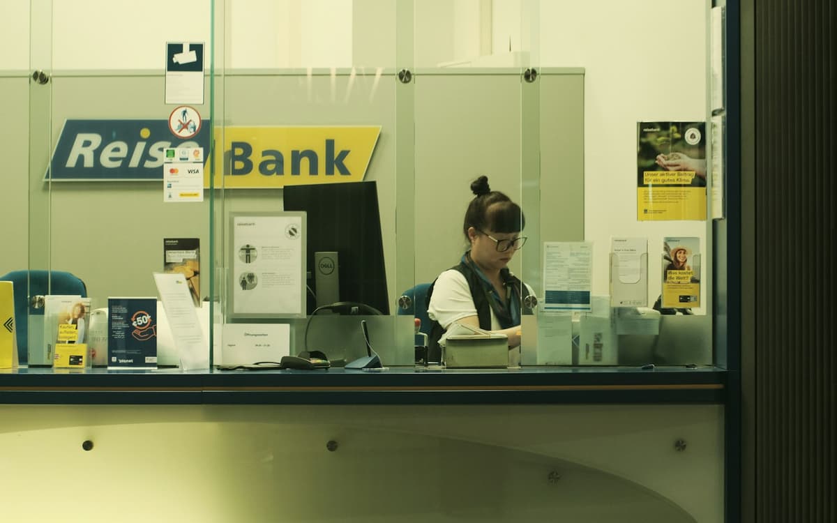 A bank teller at a counter window