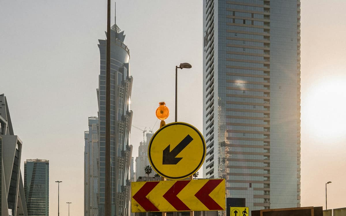 A road-works sign in front of towers in Dubai