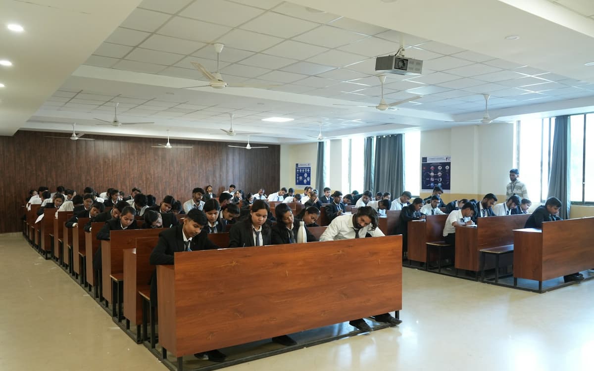 Students seated in rows in a large hall