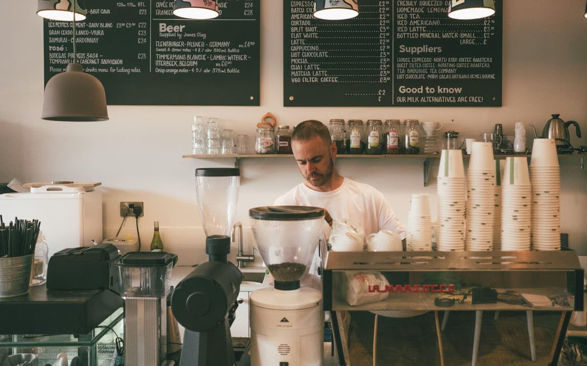A barista working behind the counter of a café