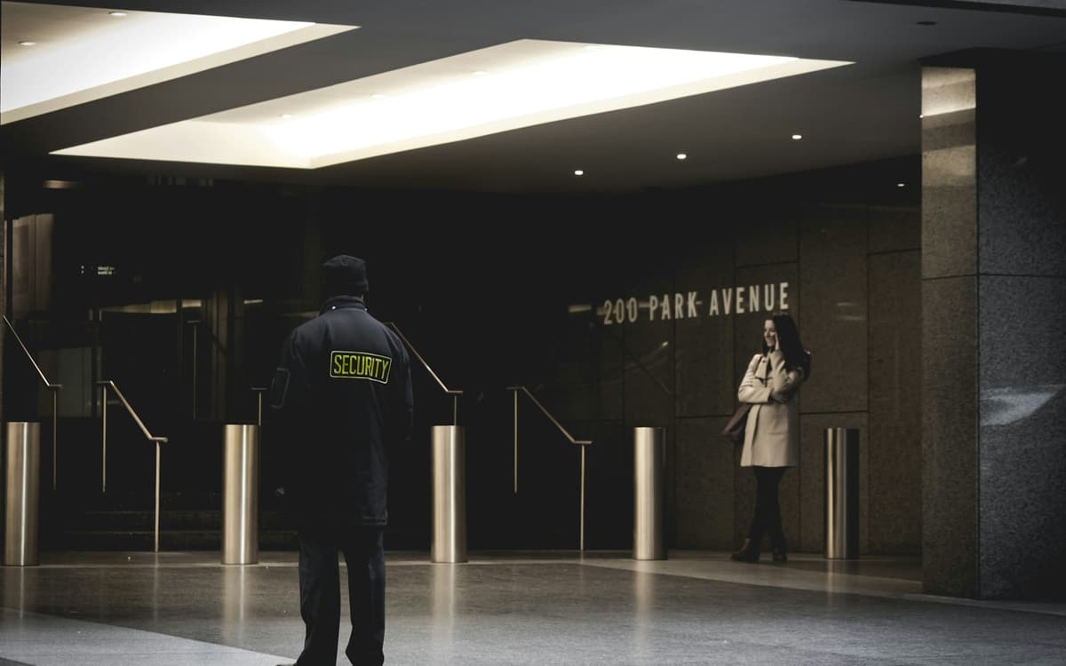 A security guard on duty in a building lobby