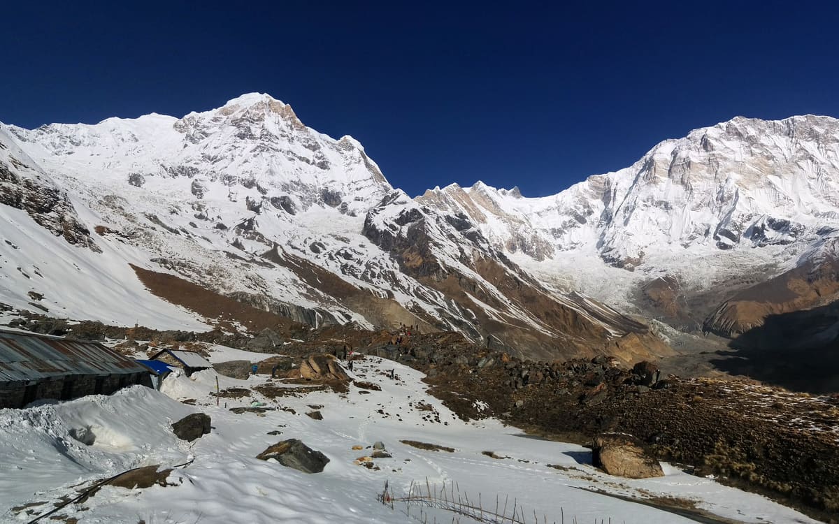 Annapurna Base Camp under snow, with the Annapurna massif behind