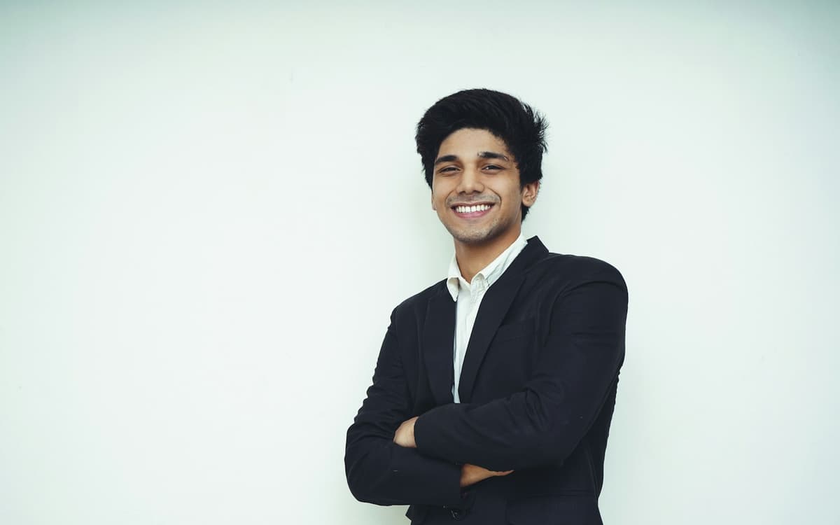 A smiling young man in a blazer